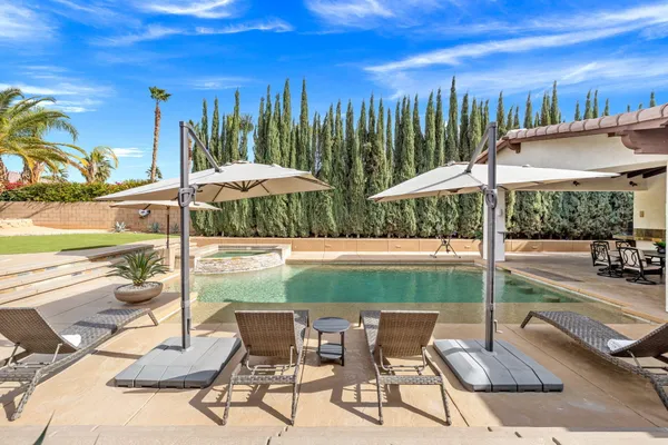 a living room with couches a fireplace and a flat screen tv