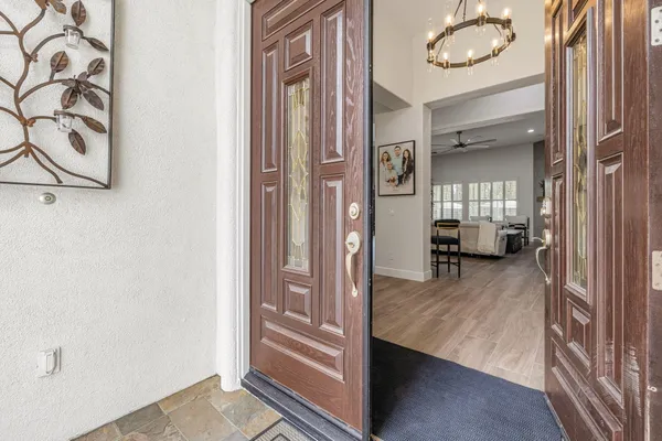 a kitchen with stainless steel appliances a sink cabinets and wooden floor