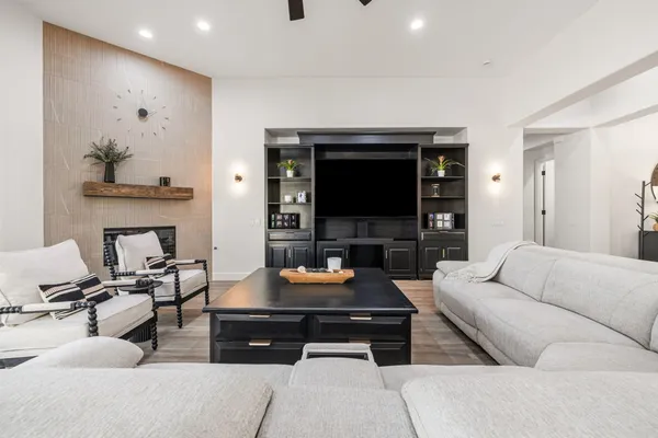 a living room with granite countertop furniture a chandelier a large window and potted plant
