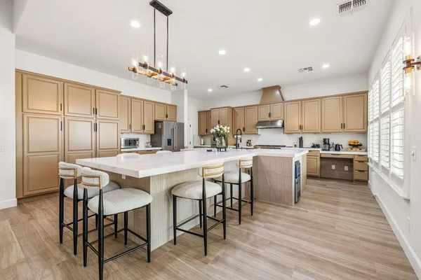 a spacious bedroom with a large bed and a flat screen tv