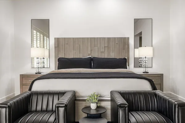 a spacious bedroom with a bed a couch and a window