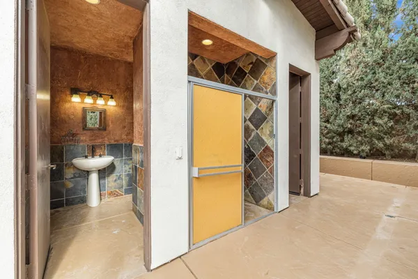 a view of a patio with a table under an umbrella