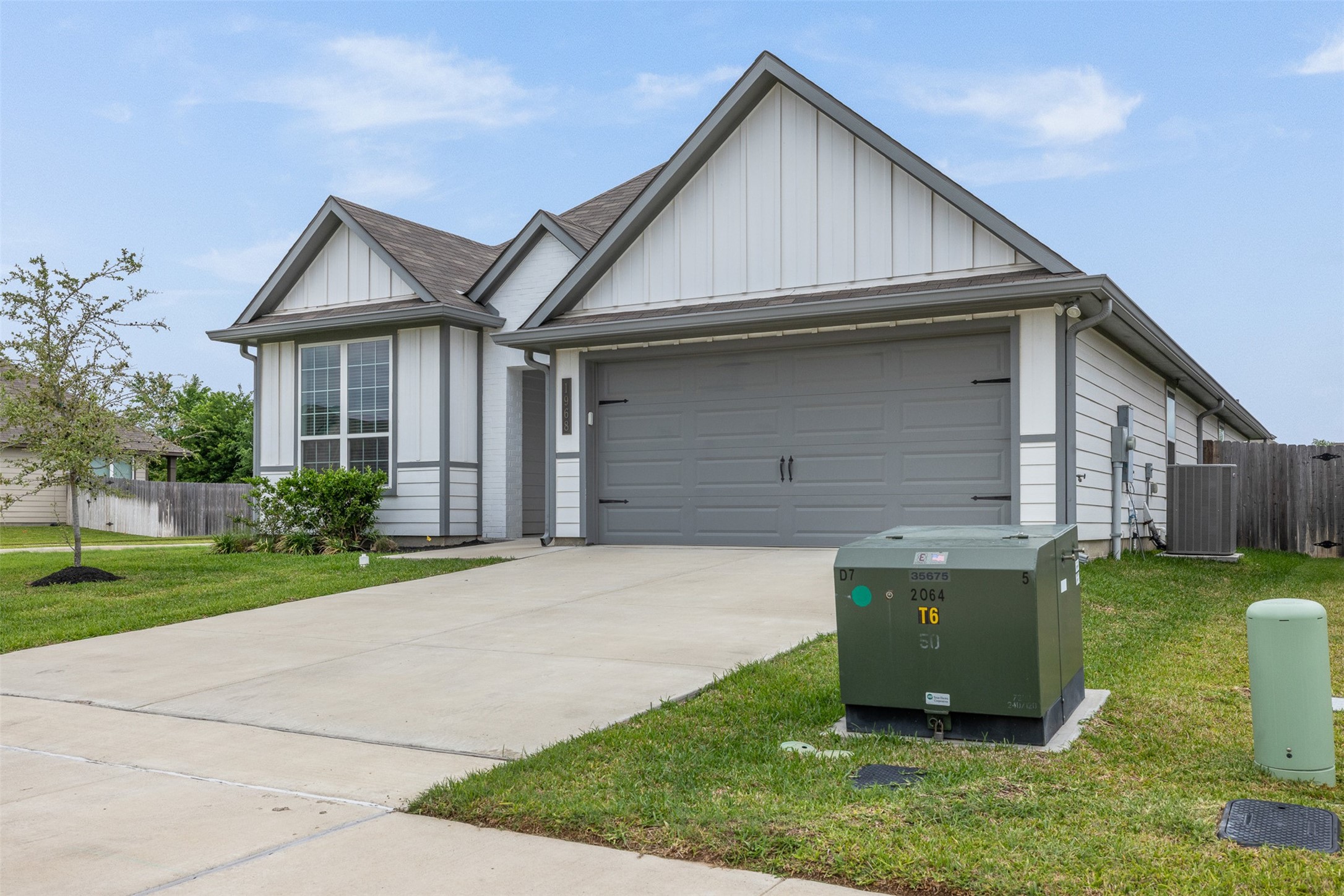 1968 Chief Street Bryan, TX 77807 - Photo 27 of 27 This is a modern single-story house with a two-car garage and a clean, well-kept exterior. The home features a spacious driveway and a small front yard with minimal landscaping. The design includes peaked roofs and large windows, offering a contemporary look.