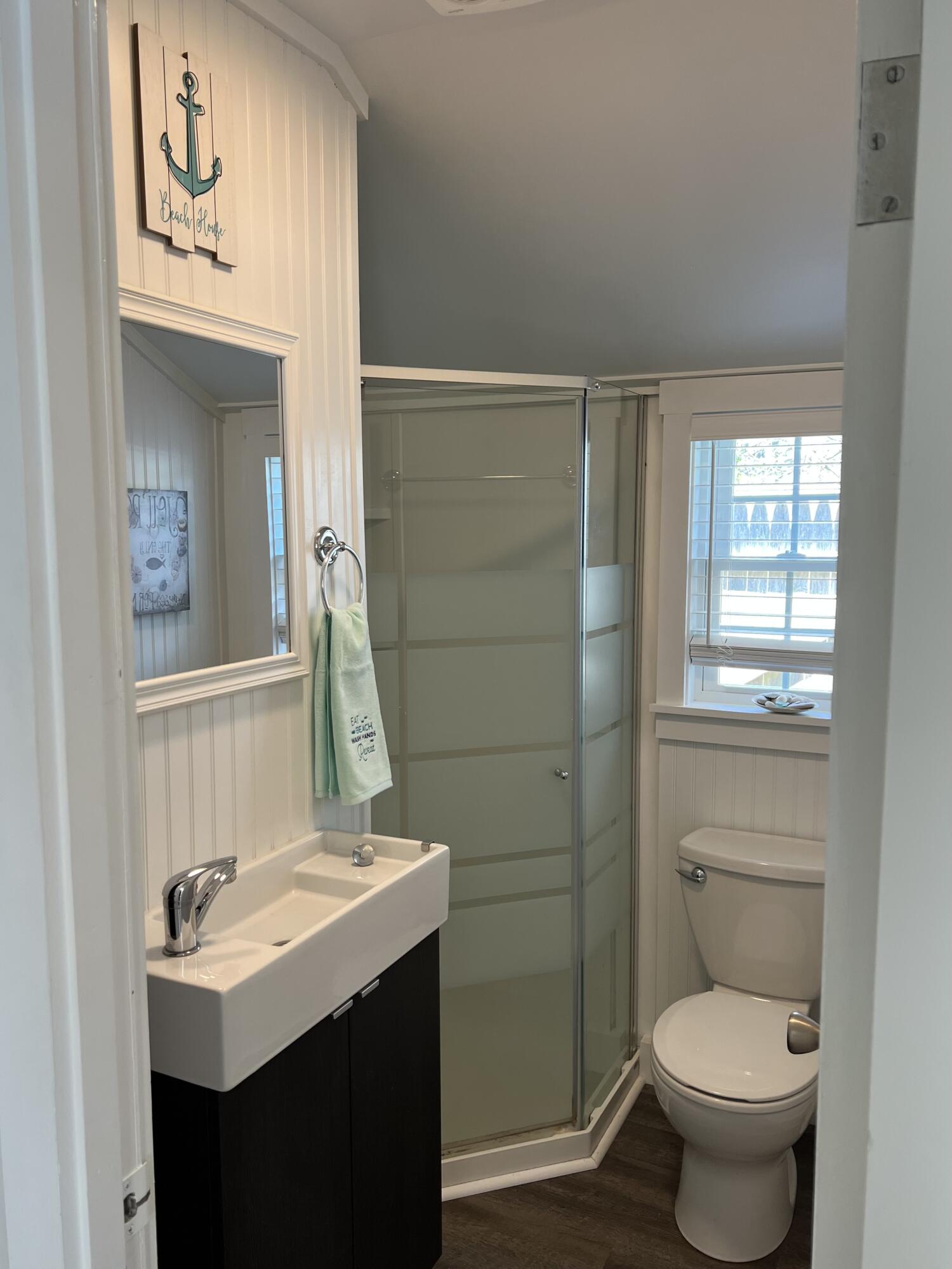 209 Lower County Road Dennis Port, MA 02639 - Photo 18 of 39 a bathroom with a toilet sink and mirror