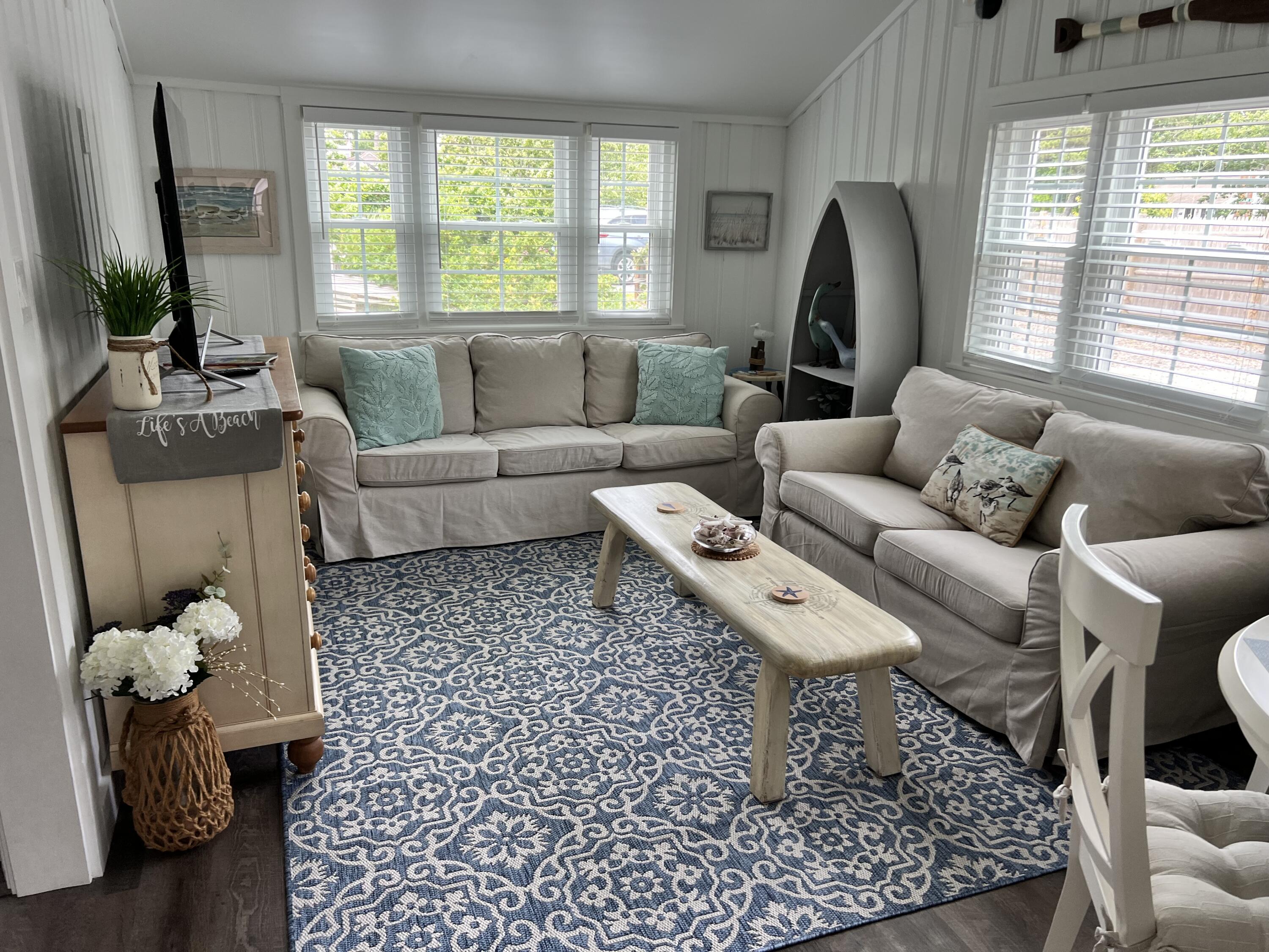 209 Lower County Road Dennis Port, MA 02639 - Photo 22 of 39 a living room with furniture and a large window