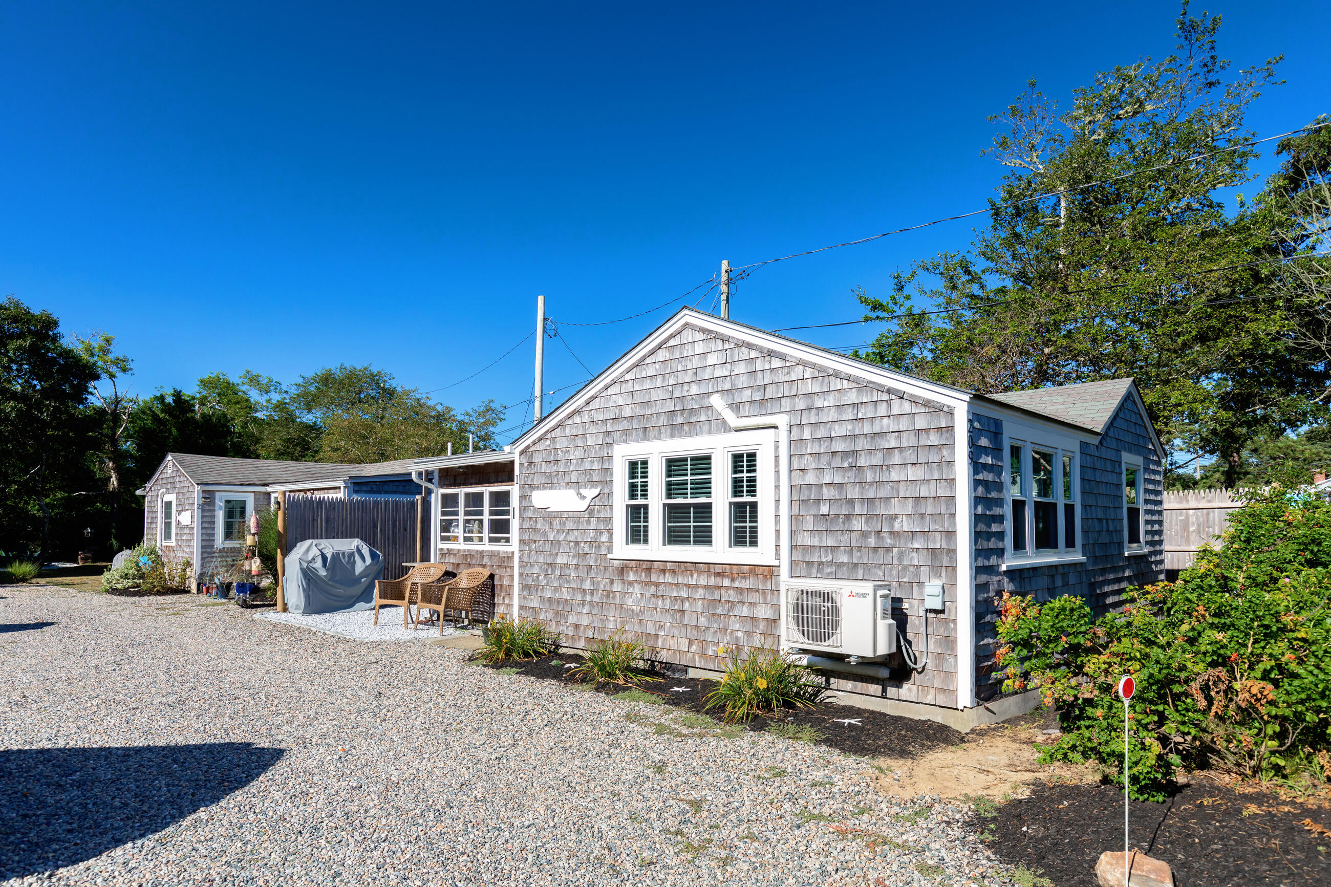 209 Lower County Road Dennis Port, MA 02639 - Photo 3 of 39 a view of a house with a yard and potted plants