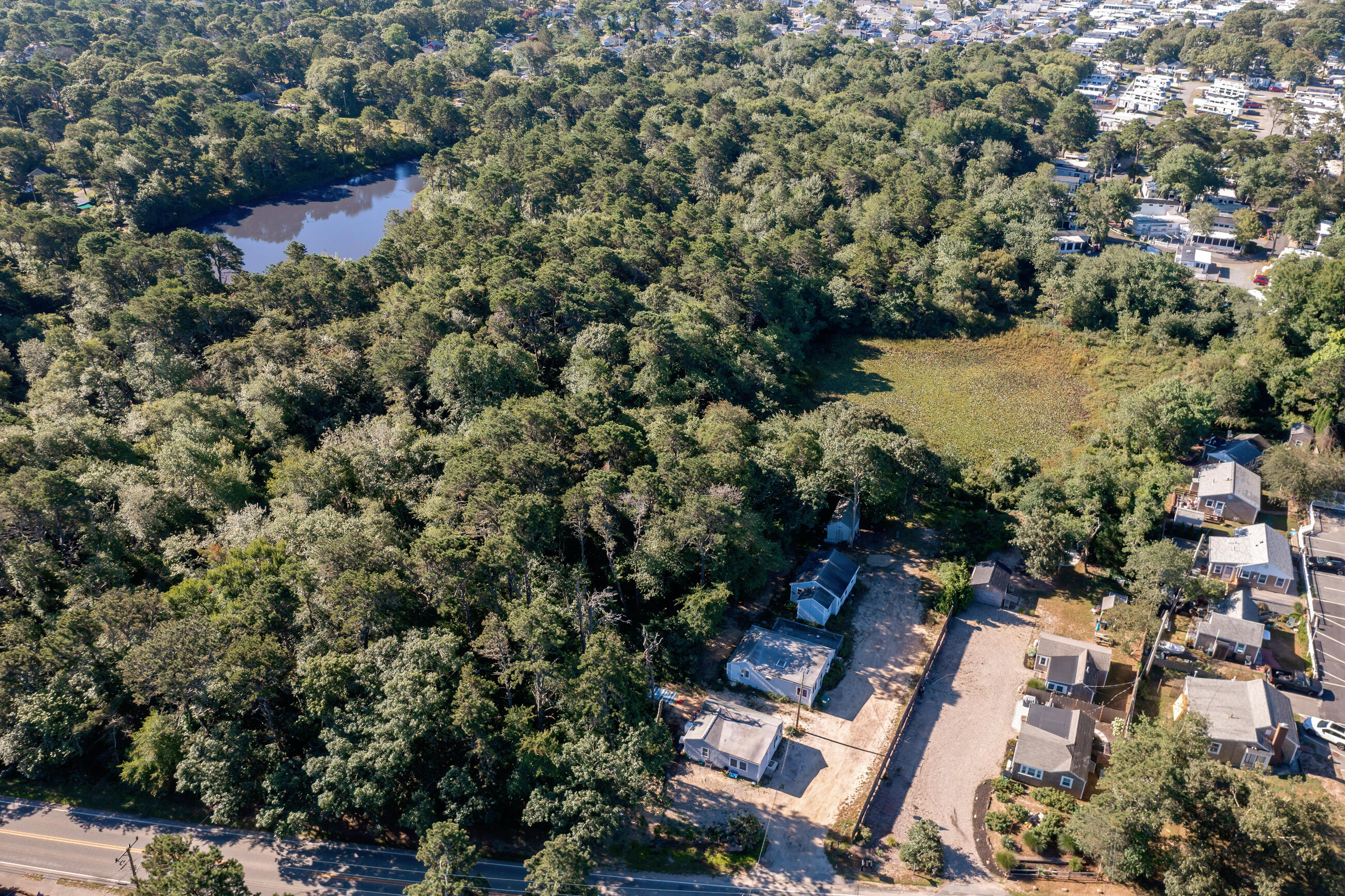 209 Lower County Road Dennis Port, MA 02639 - Photo 33 of 39 an aerial view of residential house with outdoor space and trees all around