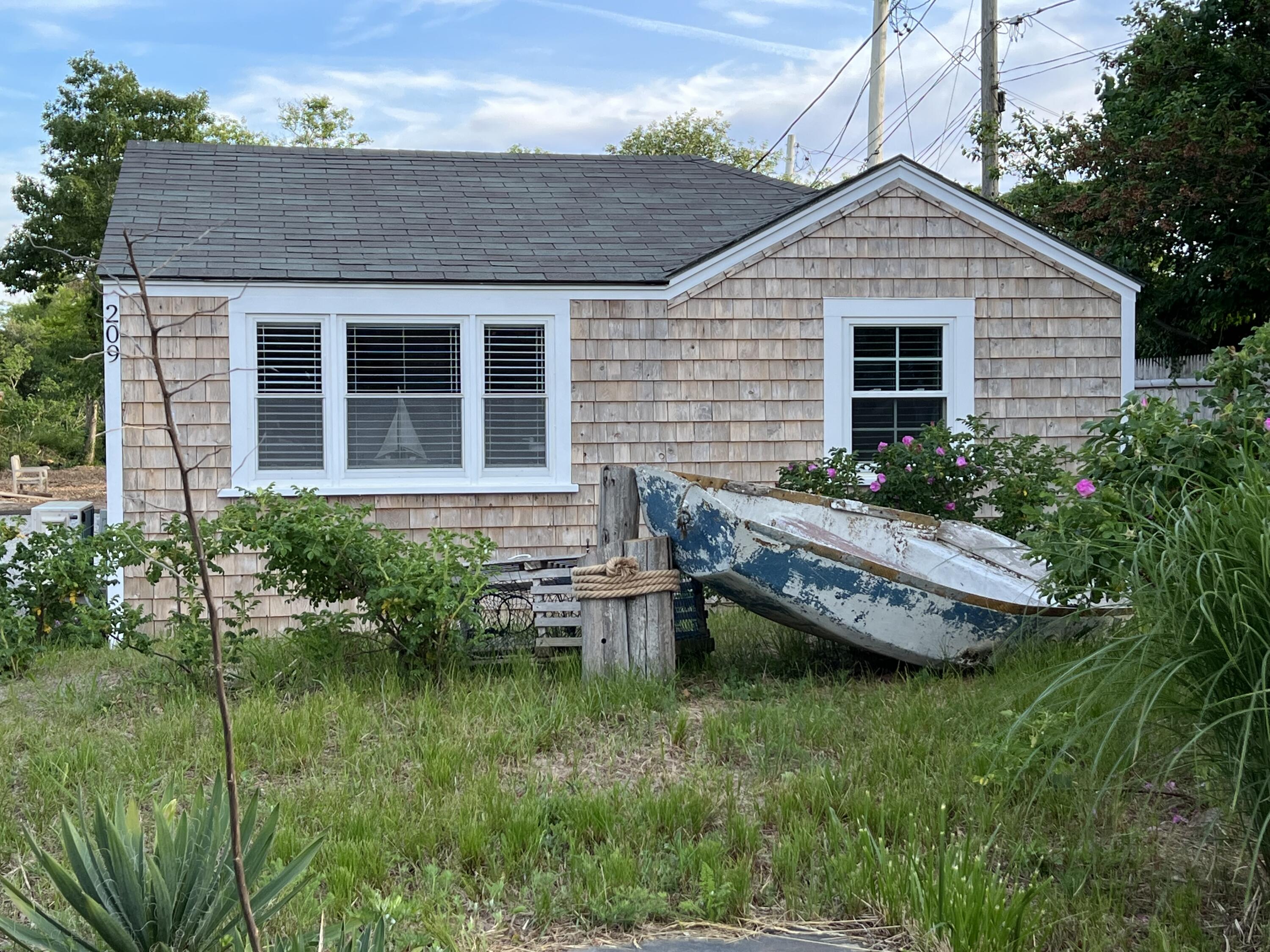 209 Lower County Road Dennis Port, MA 02639 - Photo 4 of 39 a backyard of a house with outdoor seating