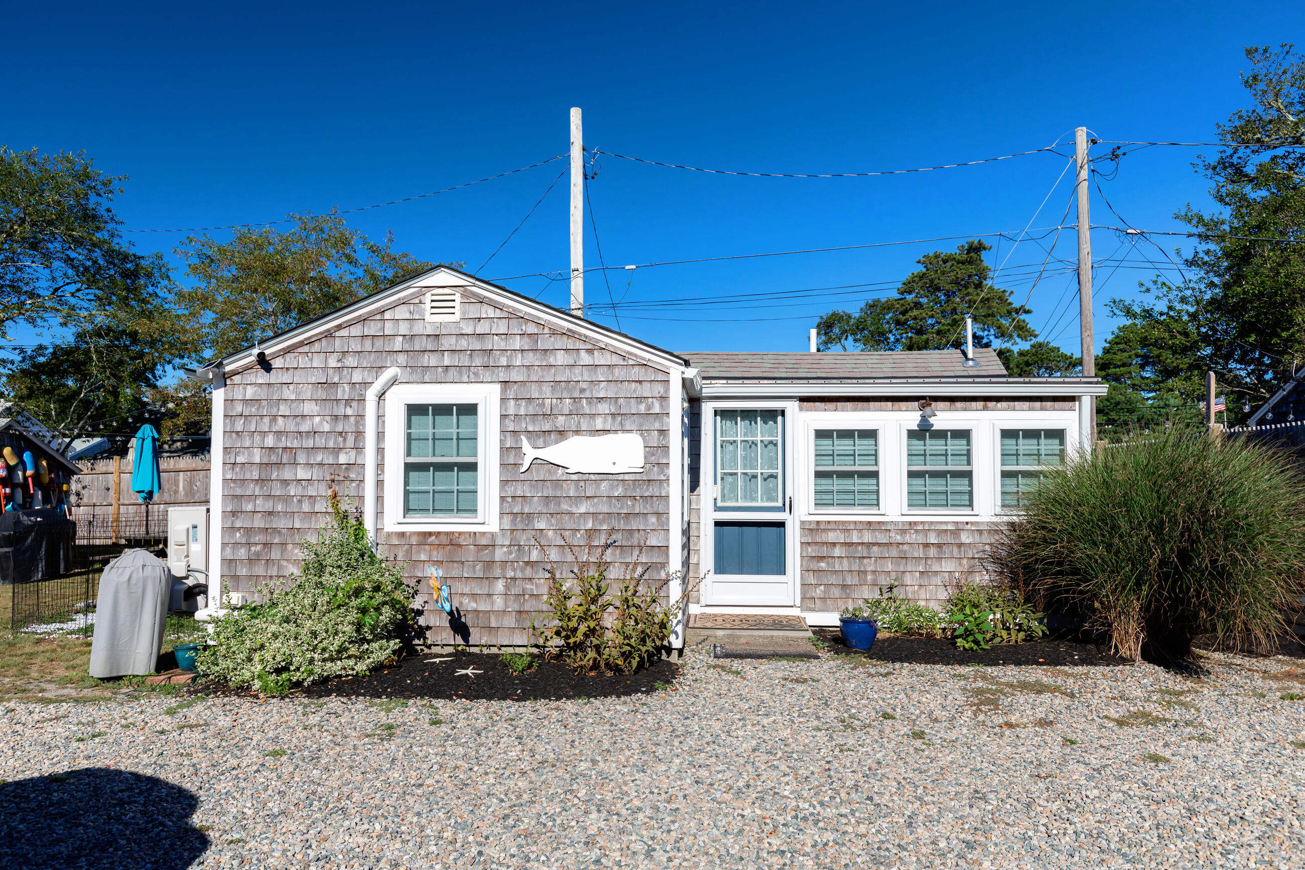 209 Lower County Road Dennis Port, MA 02639 - Photo 7 of 39 a front view of a house with garden