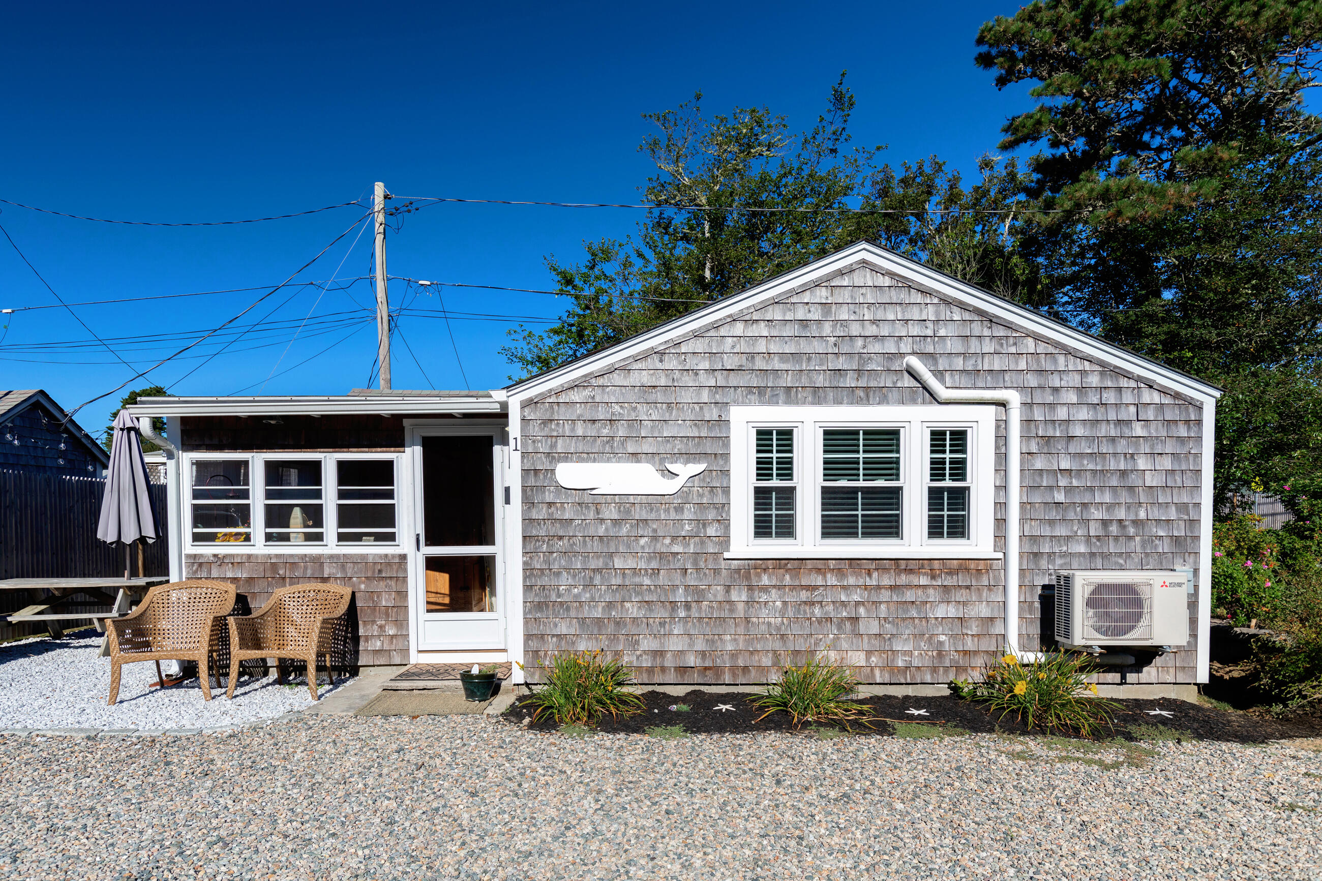 209 Lower County Road Dennis Port, MA 02639 - Photo 8 of 39 a front view of a house with patio