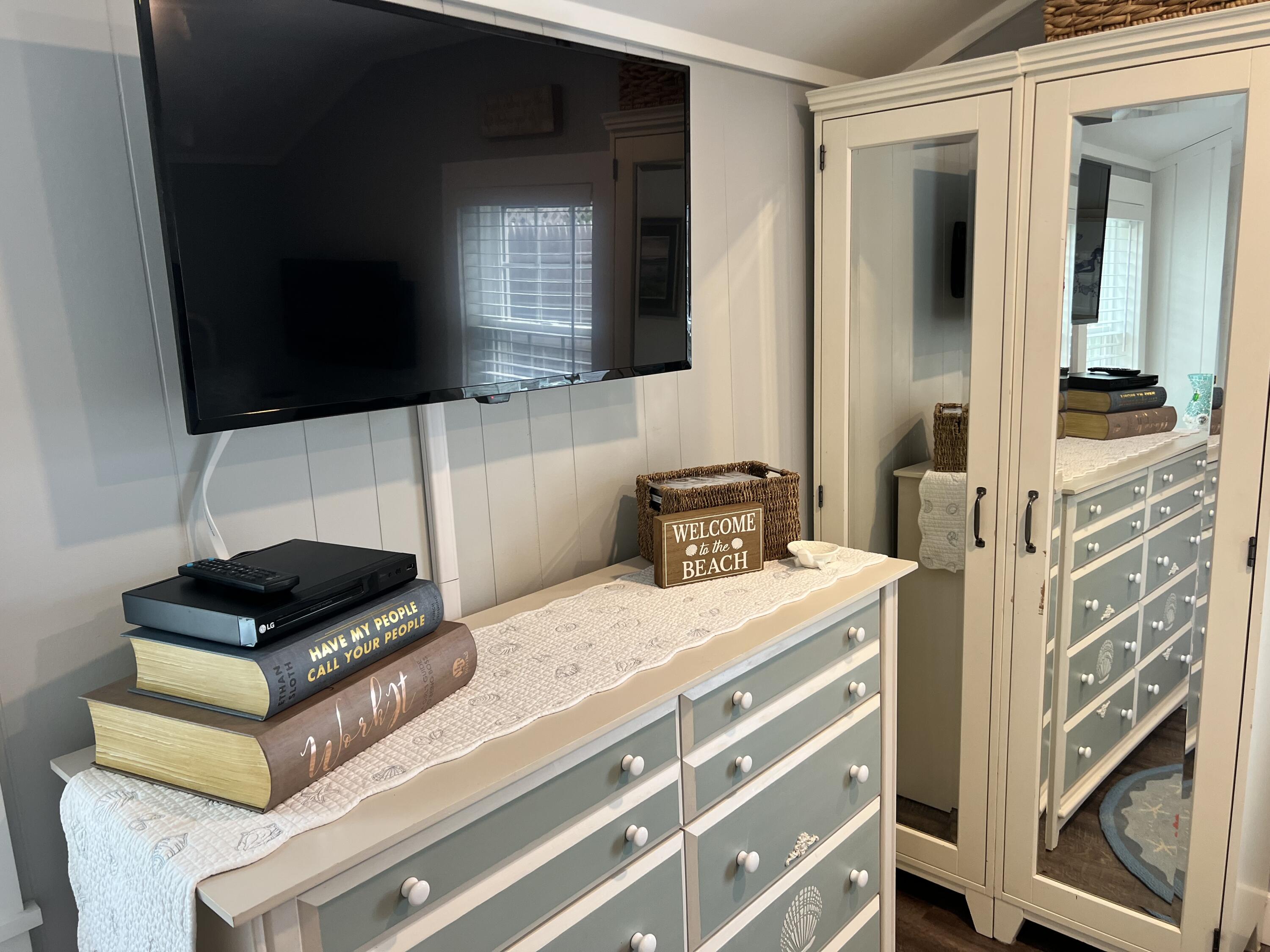 209 Lower County Road Dennis Port, MA 02639 - Photo 9 of 39 a bedroom with a bed and a flat screen tv