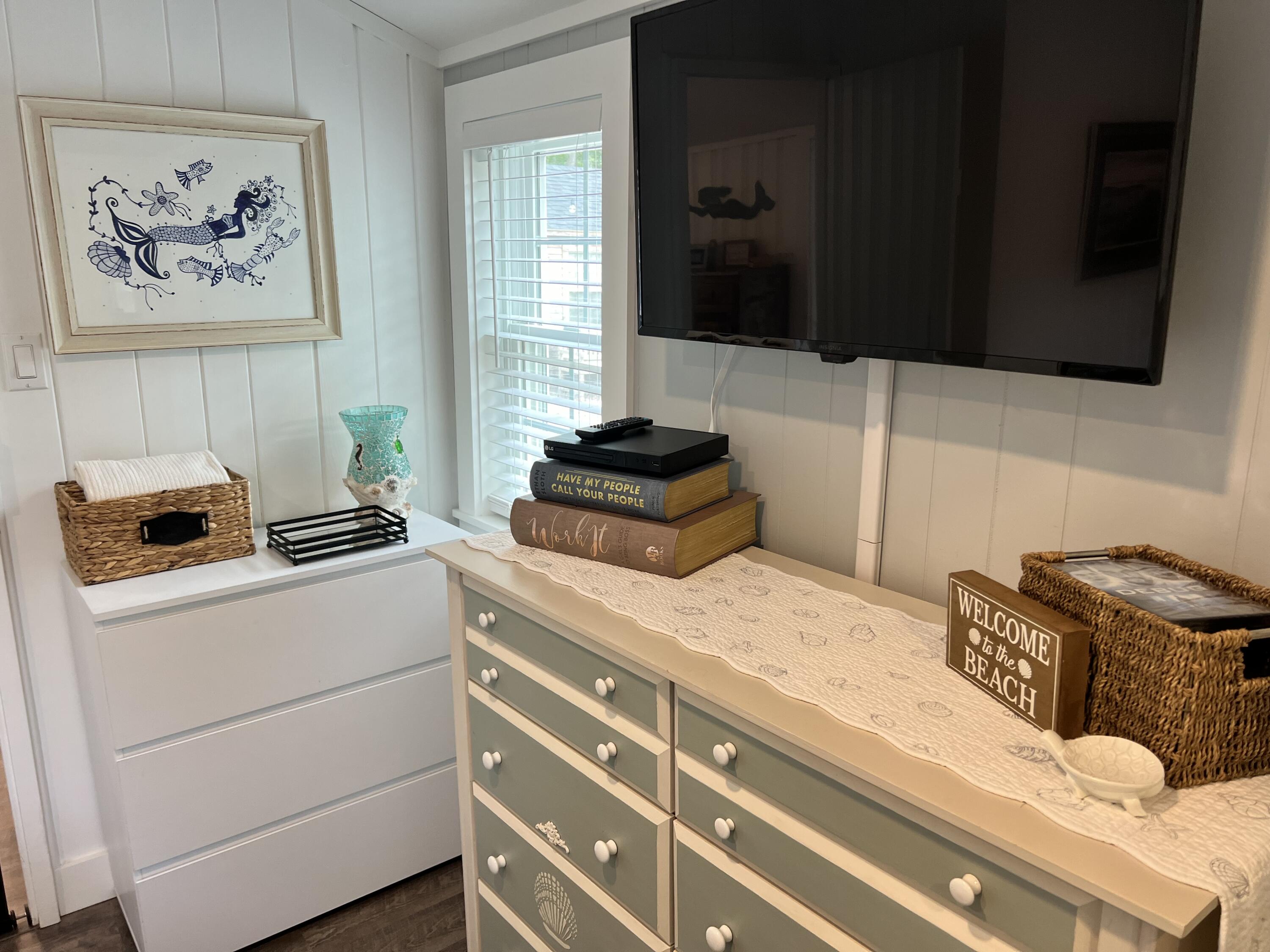 209 Lower County Road Dennis Port, MA 02639 - Photo 10 of 39 a bedroom with a bed and a cabinet