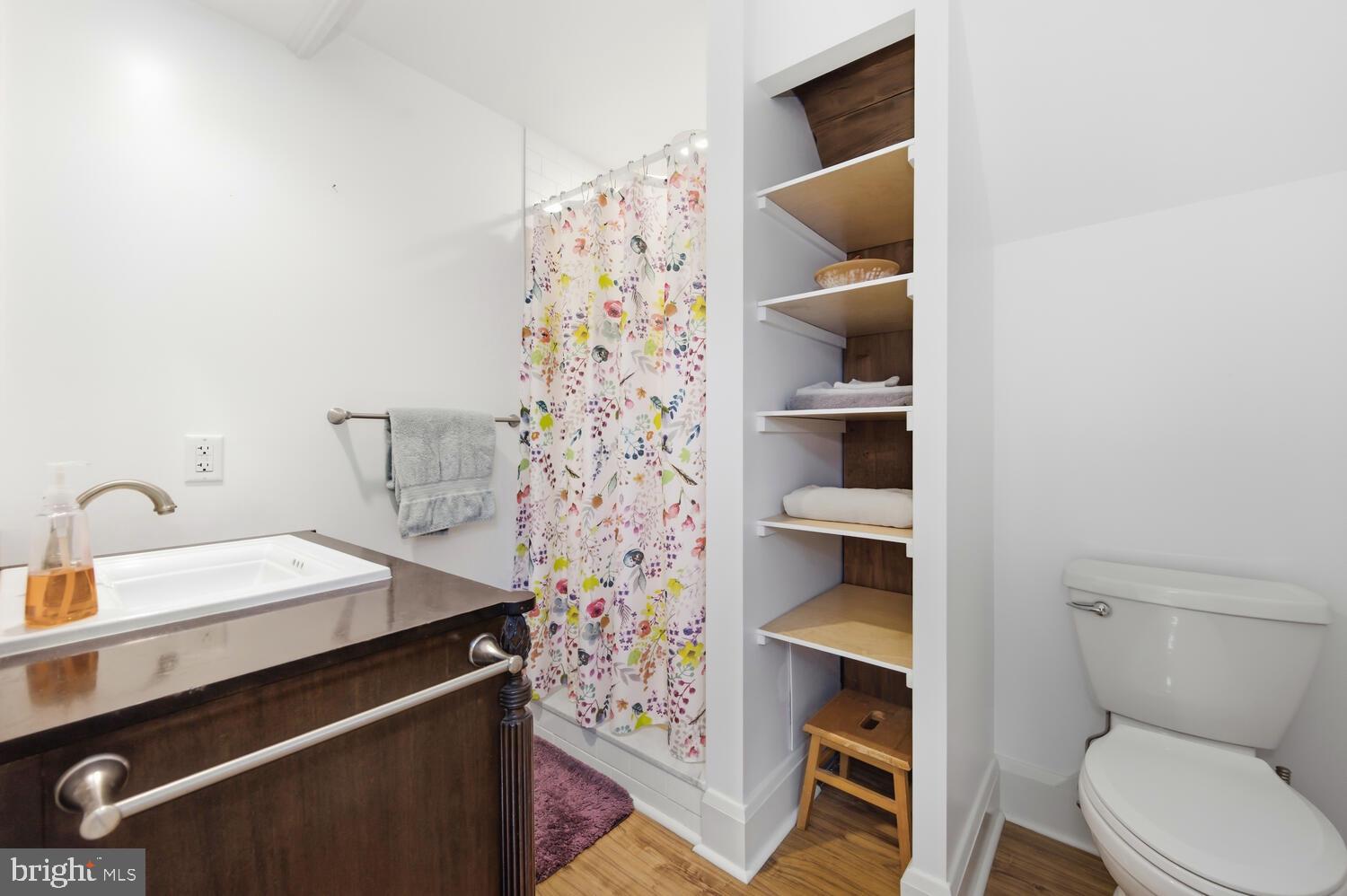 7651 Main Street Tilghman, MD 21671 - Photo 13 of 30 a bathroom with a toilet sink and shower