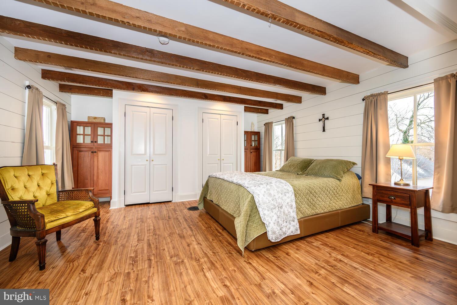 7651 Main Street Tilghman, MD 21671 - Photo 15 of 30 a bedroom with a bed and wooden floor