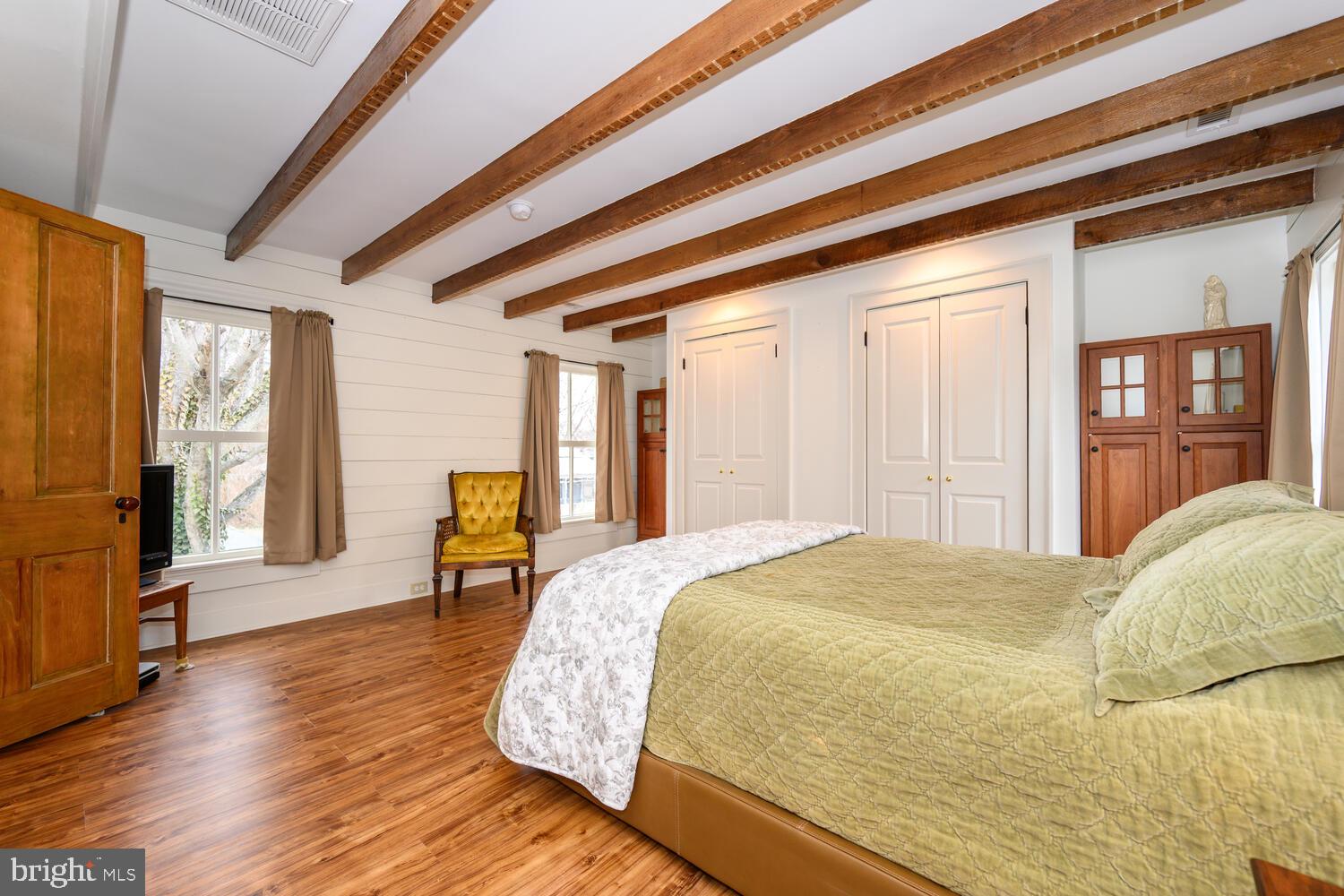 7651 Main Street Tilghman, MD 21671 - Photo 16 of 30 a bed sitting in a spacious bedroom next to a window