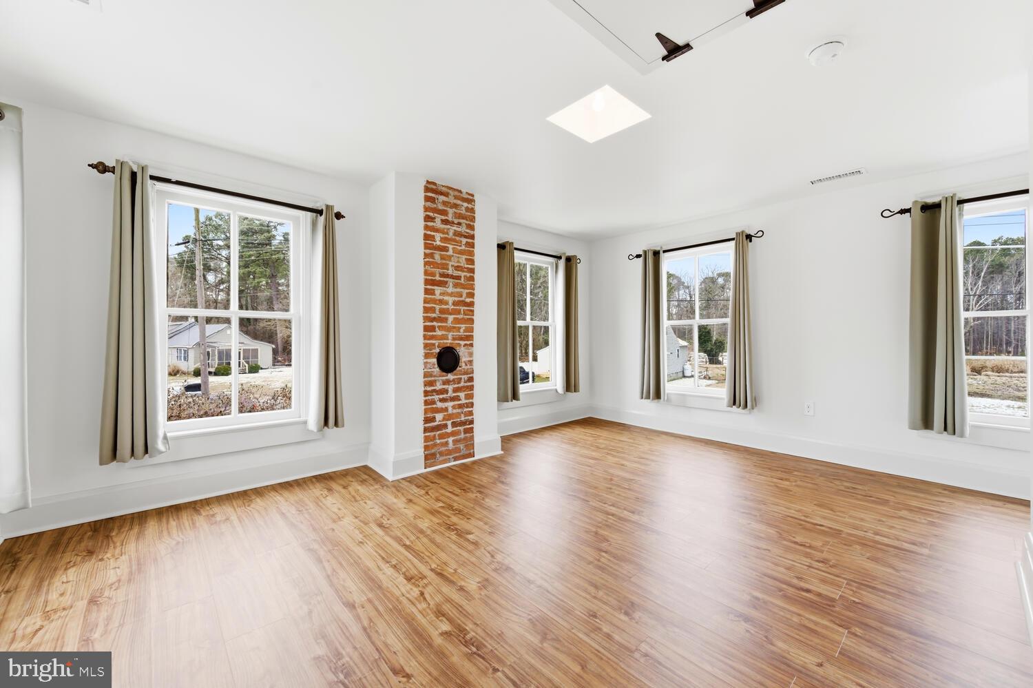 7651 Main Street Tilghman, MD 21671 - Photo 21 of 30 a view of an empty room with wooden floor and a window