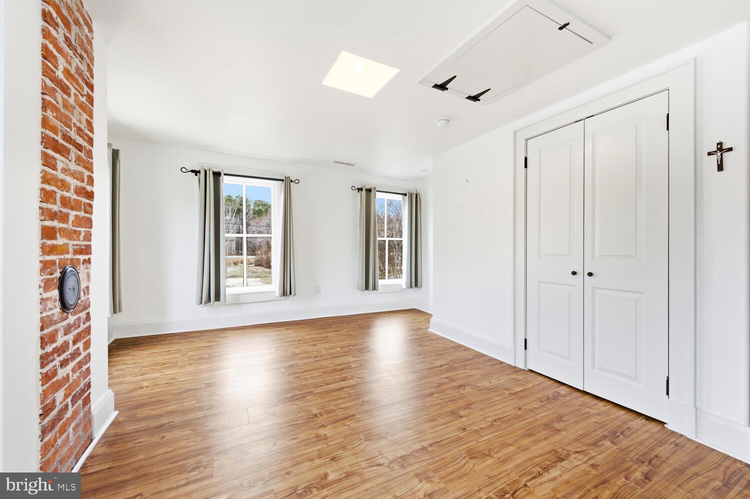 7651 Main Street Tilghman, MD 21671 - Photo 22 of 30 a view of an empty room with wooden floor and a window