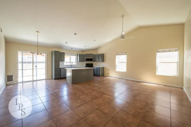 a view of kitchen with stove refrigerator and cabinets