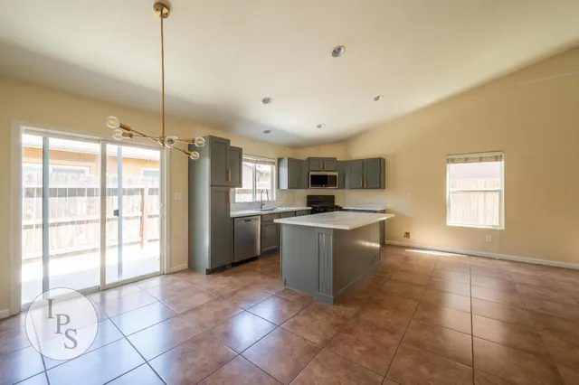 a kitchen with a stove a sink and a refrigerator
