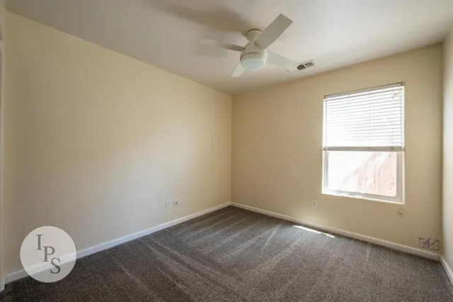 a view of a livingroom with wooden floor and a ceiling fan