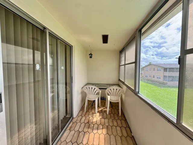 a view of a balcony with wooden floor