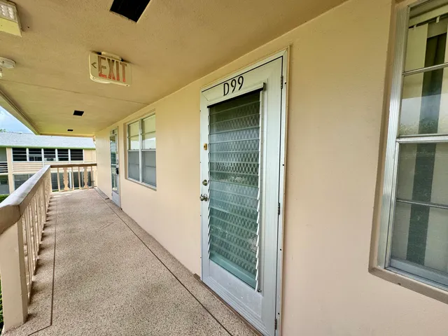 a view of a porch with furniture and front door
