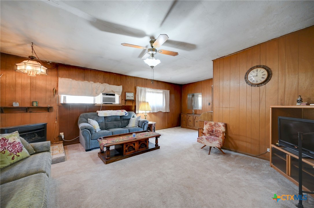 1631 East Fannin Street Luling, TX 78648 - Photo 10 of 27 a living room with furniture gym equipment and a window