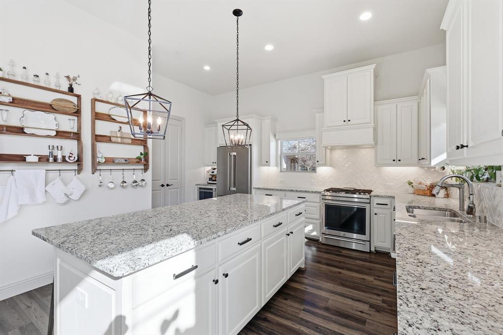 401 Lavender Lane Fairview, TX 75069 - Photo 17 of 40 a kitchen with stainless steel appliances granite countertop a stove a sink and a refrigerator