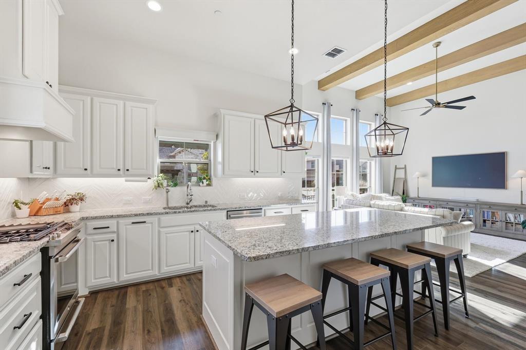 401 Lavender Lane Fairview, TX 75069 - Photo 19 of 40 a kitchen with center island table chairs sink and cabinets