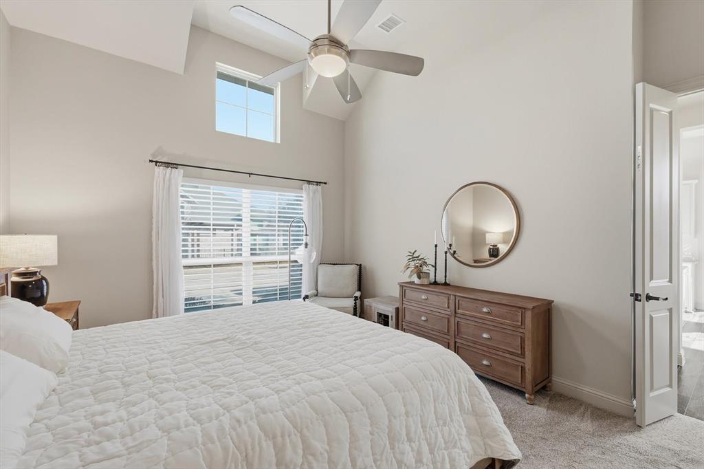 401 Lavender Lane Fairview, TX 75069 - Photo 25 of 40 a bedroom with a large bed and a chandelier