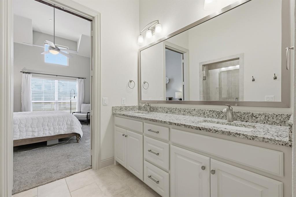 401 Lavender Lane Fairview, TX 75069 - Photo 27 of 40 a en suite bathroom with a granite countertop double vanity sink and a mirror