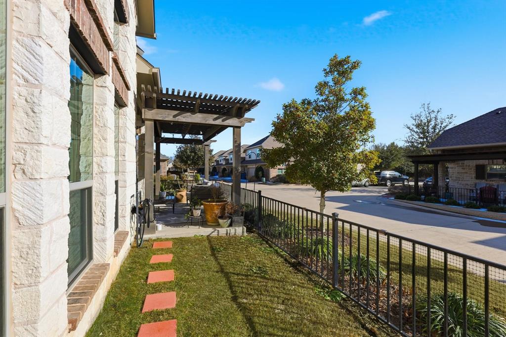 401 Lavender Lane Fairview, TX 75069 - Photo 37 of 40 a view of a patio with table and chairs with wooden floor and fence
