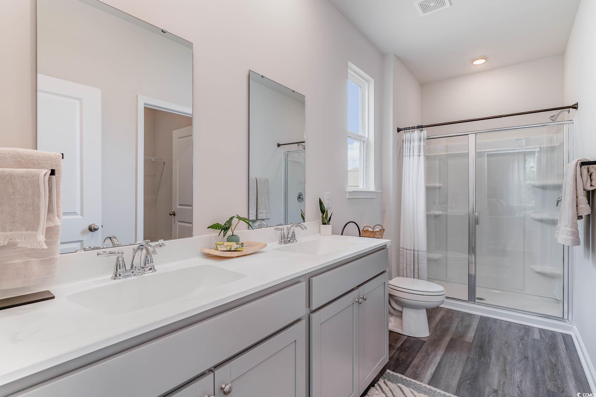 368 Rookroost Circle Conway, SC 29526 - Photo 14 of 19 Bathroom featuring a shower stall, wood finished f