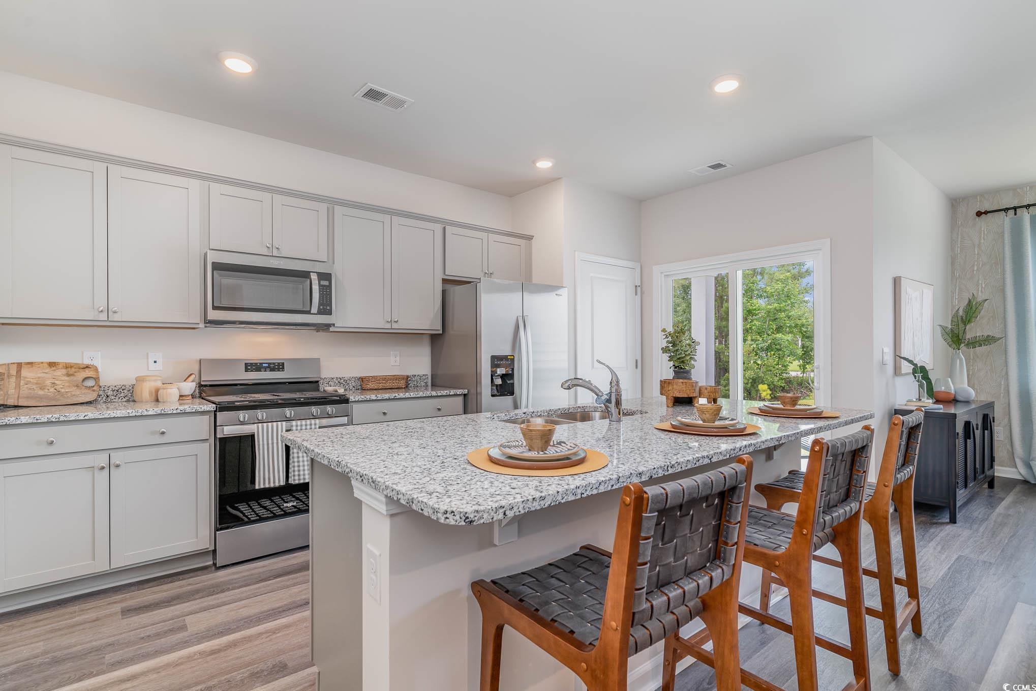 368 Rookroost Circle Conway, SC 29526 - Photo 3 of 19 Kitchen with visible vents, a breakfast bar, light