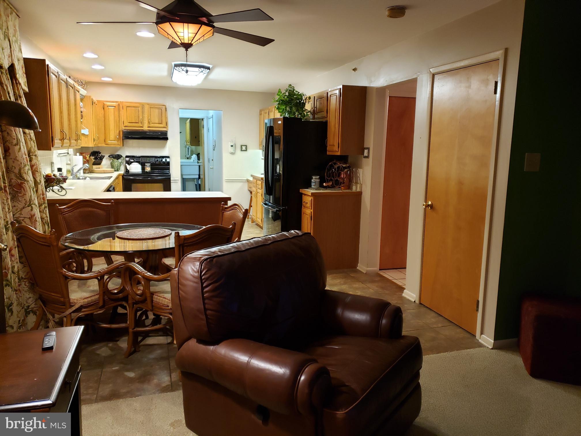 534 Farnum Road Media, PA 19063 - Photo 14 of 43 a living room with furniture a flat screen tv and kitchen view