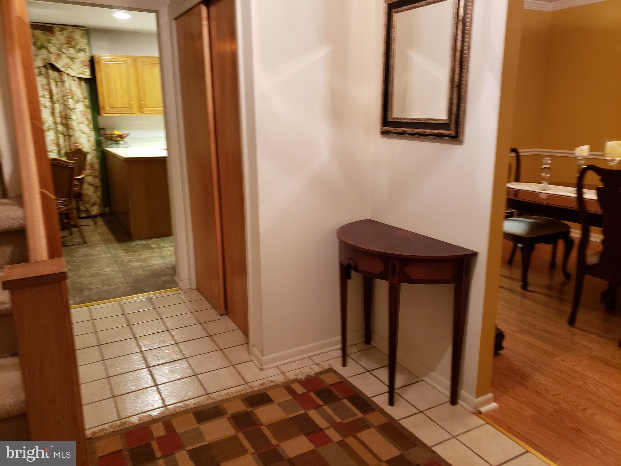 534 Farnum Road Media, PA 19063 - Photo 5 of 43 a view of a hallway with wooden floor and a bathroom