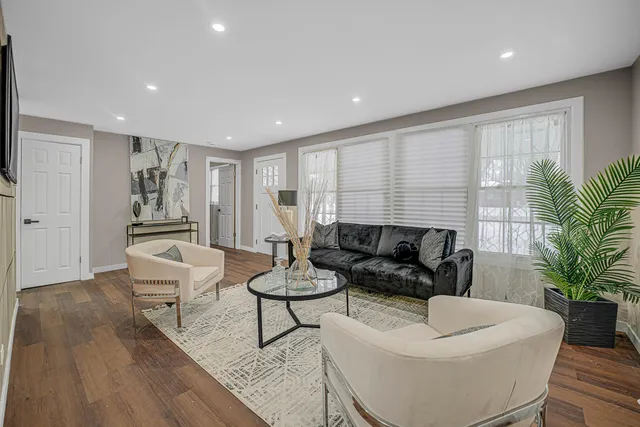 a living room with furniture and a potted plant