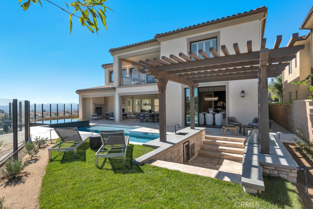 a view of a house with swimming pool and sitting area