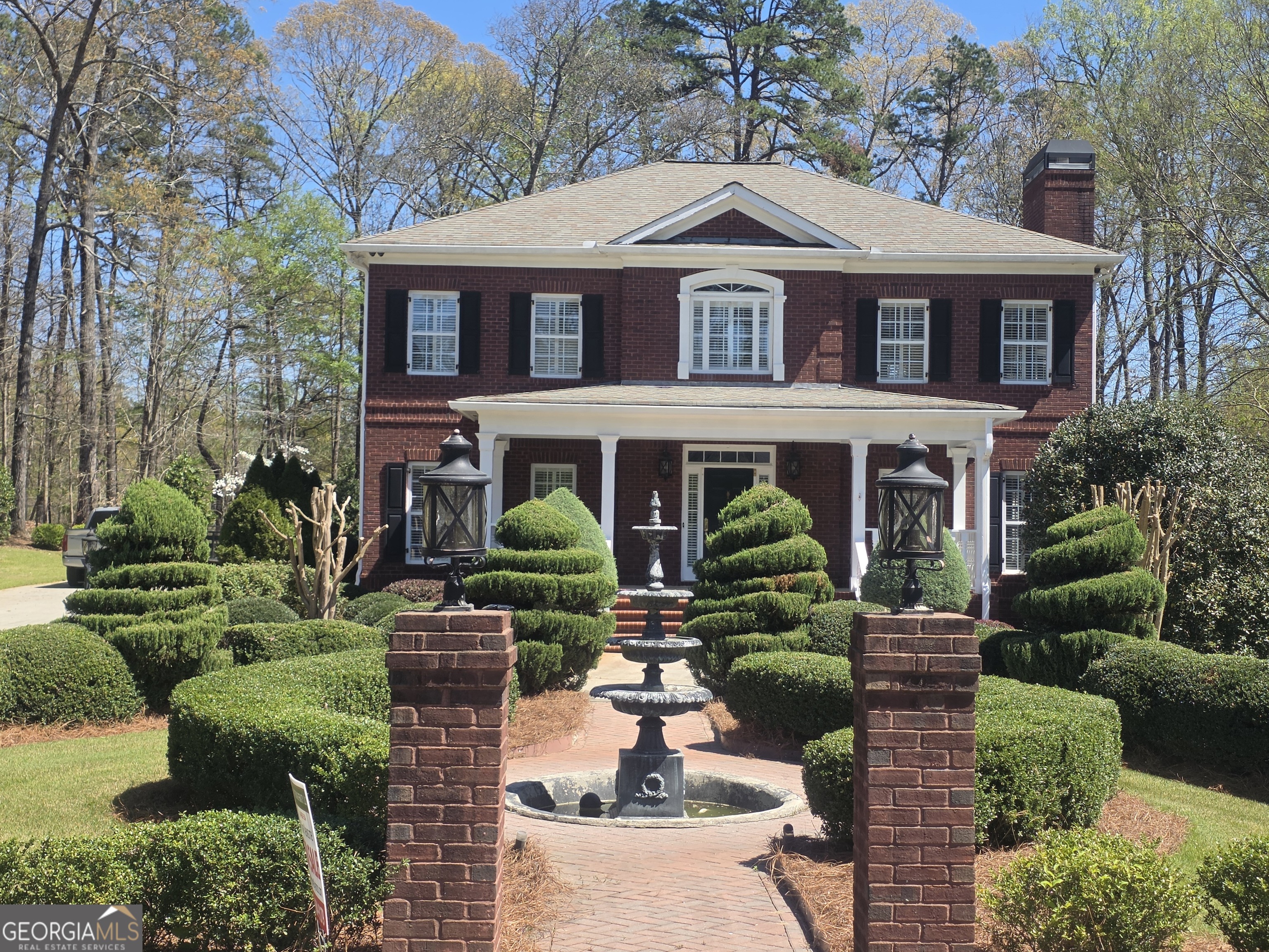 a front view of a house with garden
