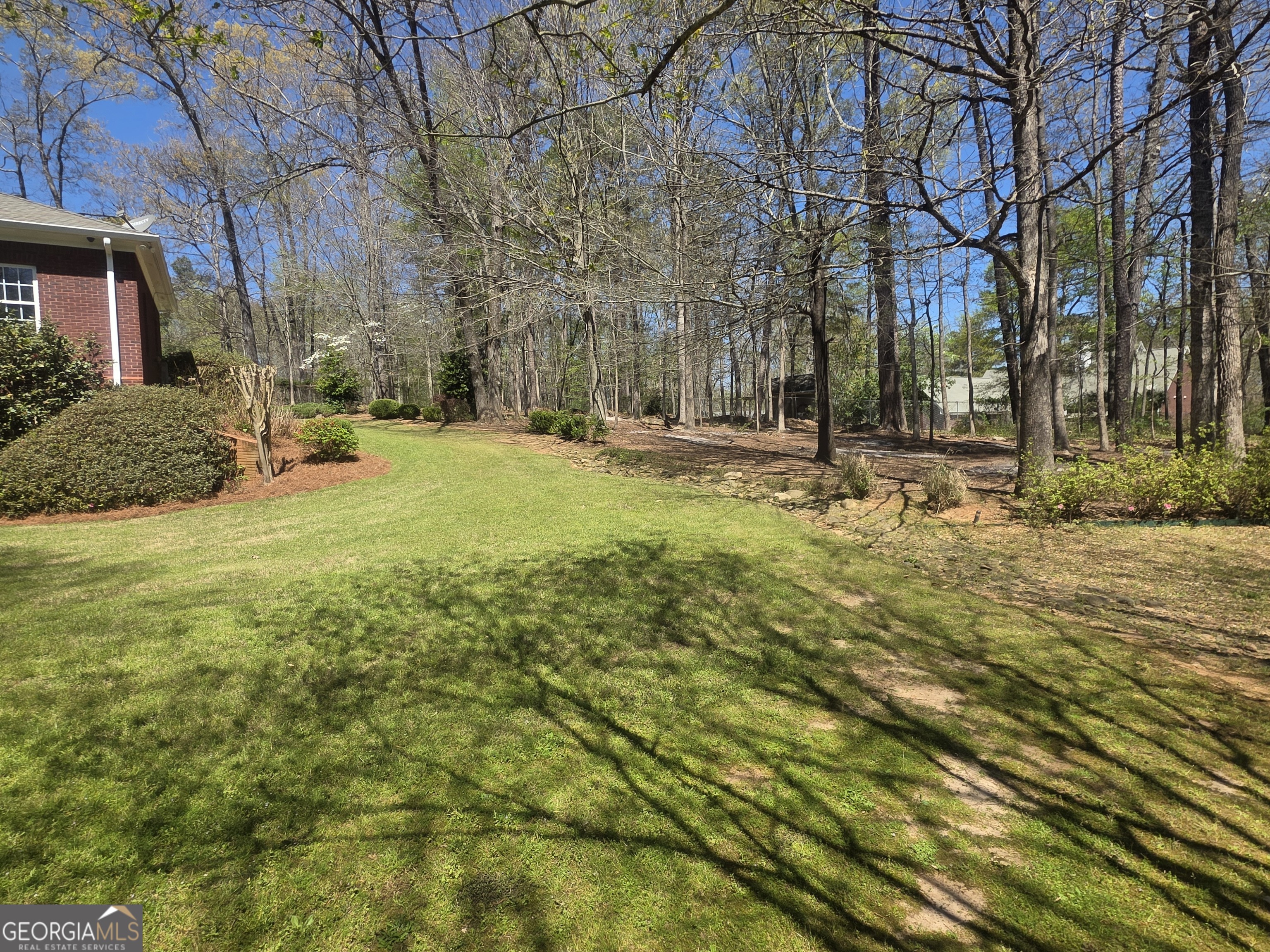 306 Calumet Lane Monroe, GA 30655 - Photo 11 of 13 a view of a yard with plants and large trees