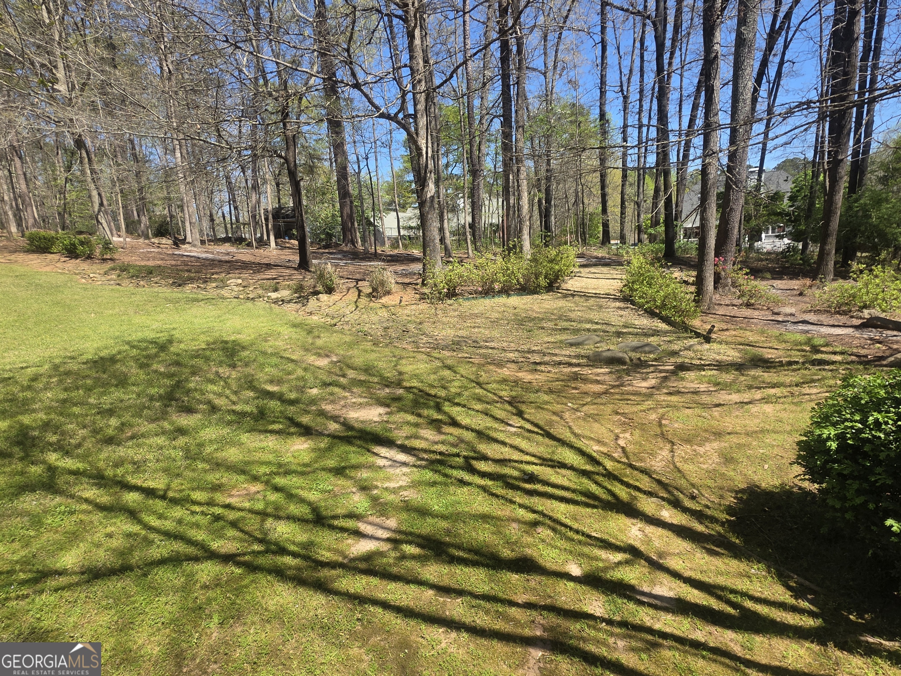 306 Calumet Lane Monroe, GA 30655 - Photo 12 of 13 a backyard of apartments with large trees