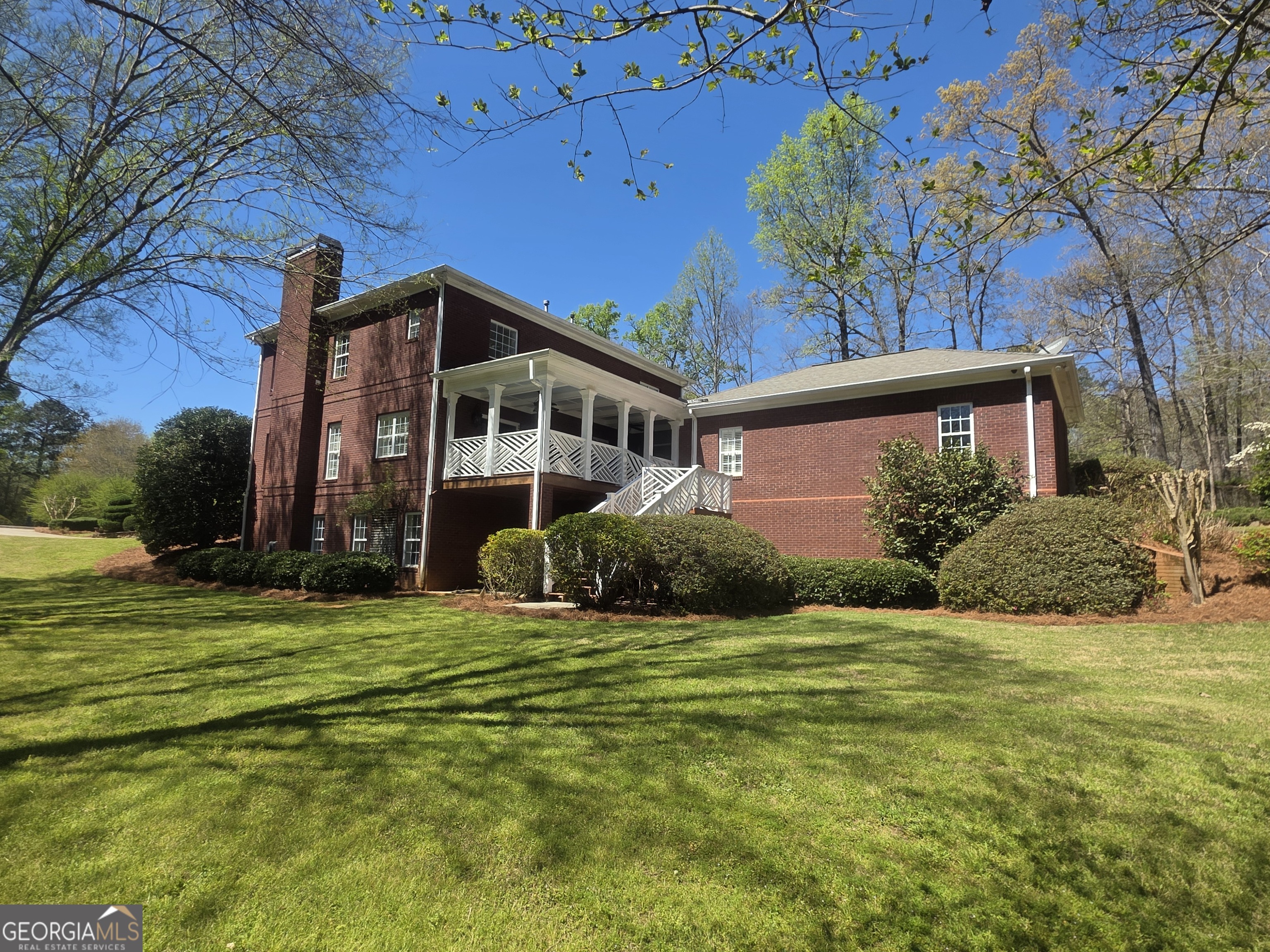 306 Calumet Lane Monroe, GA 30655 - Photo 10 of 13 a front view of a house with a garden
