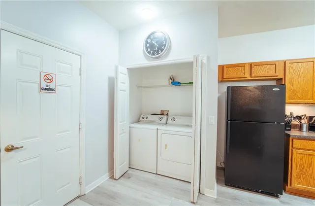 a walk in closet with wooden floor