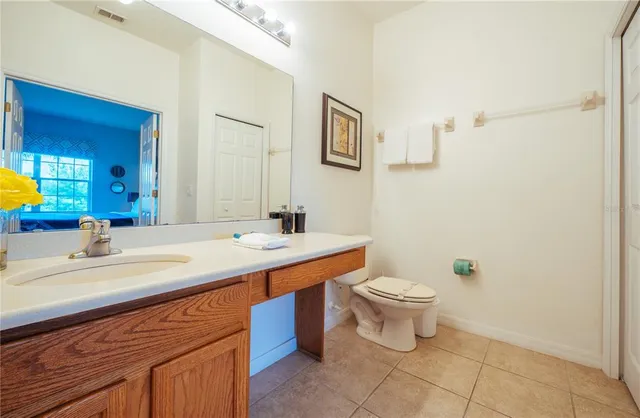 a bathroom with a granite countertop shower sink vanity and mirror