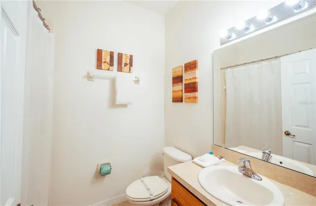 a white bath tub sitting next to a white sink and vanity