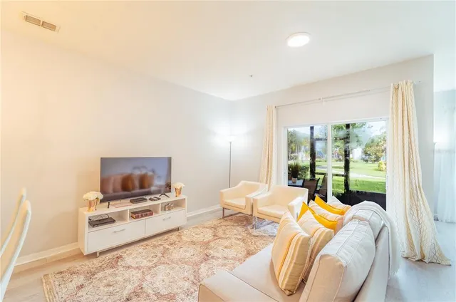 a bedroom with furniture and a flat screen tv