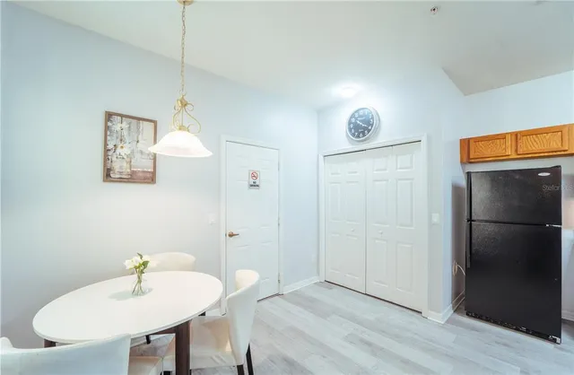 a kitchen with refrigerator and cabinets