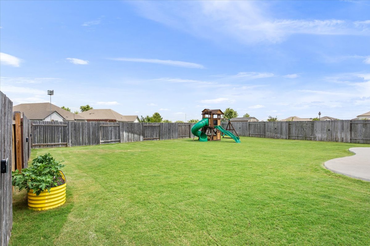 424 Millard Street Georgetown, TX 78628 - Photo 37 of 37 A spacious, enclosed backyard offers ample play space for all ages, with a wooden privacy fence.