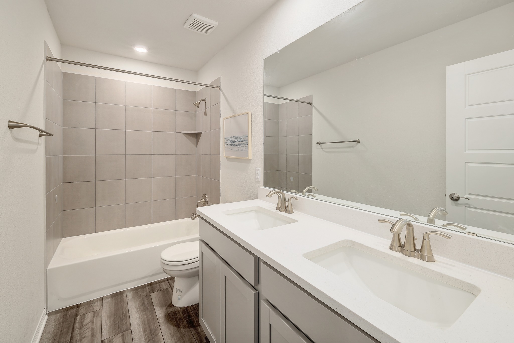 144 Sungrove Trail Georgetown, TX 78628 - Photo 23 of 40 Dual sinks and a neutral tiled bath tub in the upstairs bathroom. There is an additional storage closet just outside the bathroom.