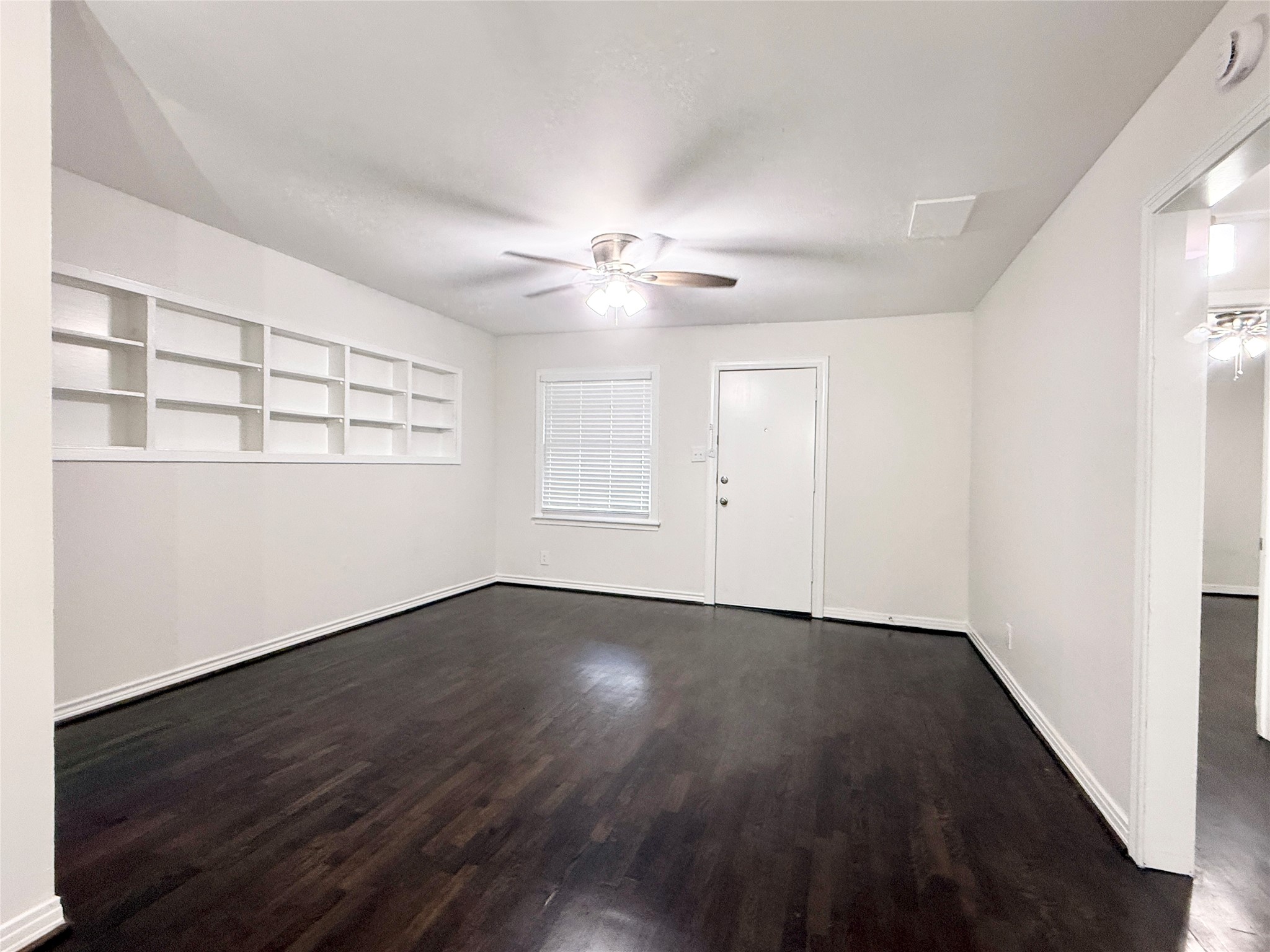 832 South Anderson Street Angleton, TX 77515 - Photo 3 of 19 an empty room with wooden floor and window